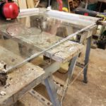 Carefully removing the rotten bottom sash with out breaking the old rippled glass