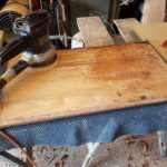 Sanding the door panel after paint scraping