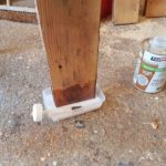 End grain of door stiles being socked up with wood hardener