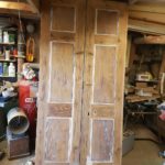 Doors ready for paint, notice panel edges are already protected.