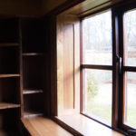 Waney edge library shelves and panelled window