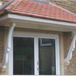 canopy with scrolled braces