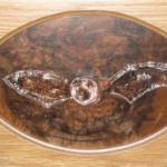 carving of bat set in cocobola veneer panel set in oak