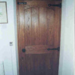 door in dark oak with arched top rail