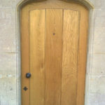 door in oak with arch in wellow bath