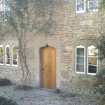 door in oak with arched top in wellow bath from a distance