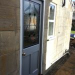 door painted idigbo with stain glass panel outside