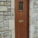 mahogany door with little arch window