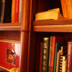 secret bookcase door showing turned posts and feather banding on shelves