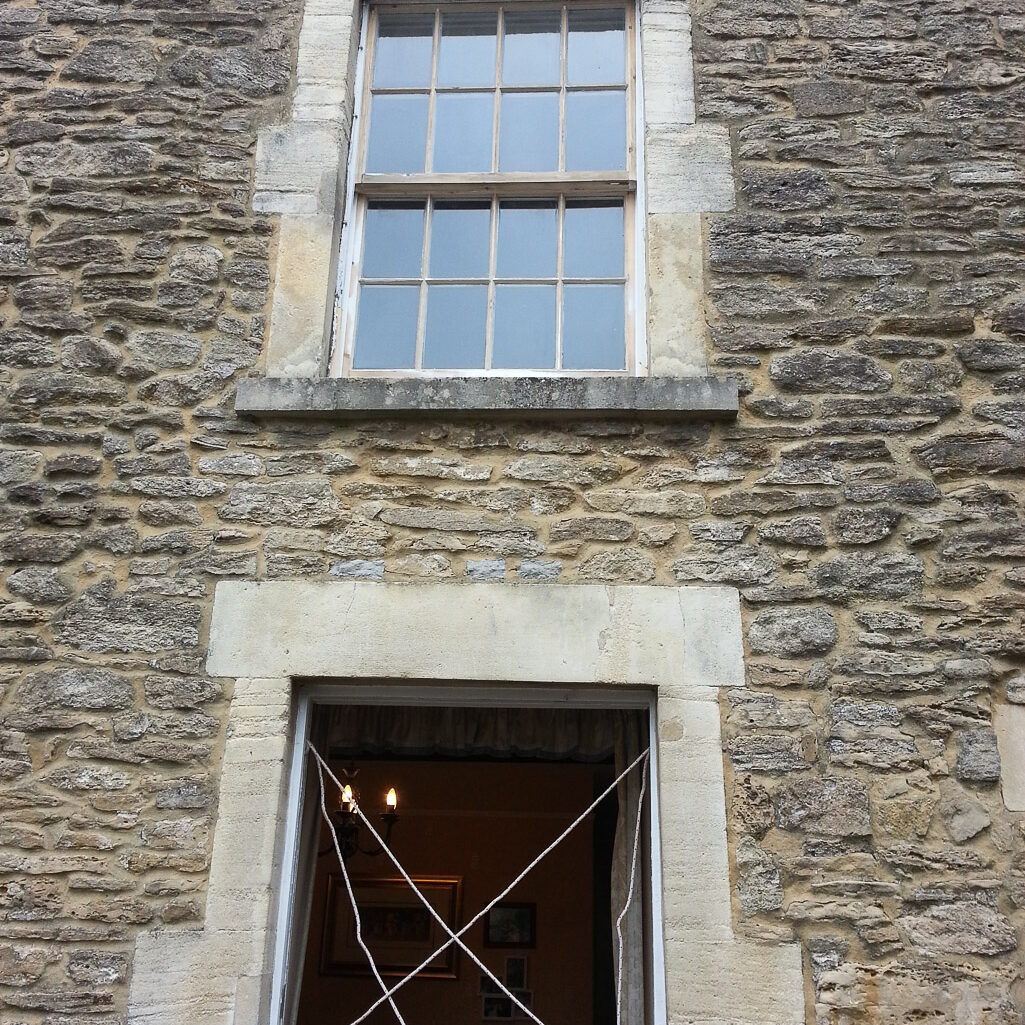 Stringing up sash weights ready for sashes on window in York St