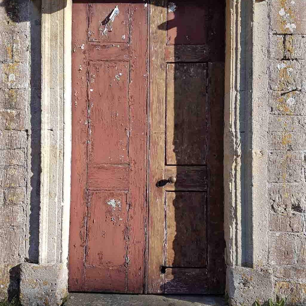Chapel door with one side part stripped and a burn hole in the lower rail